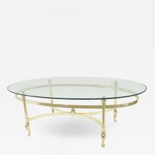 With a walnut top, solid edges, and a black steel base, let this coffee table catch the eye of any wandering guest. Contemporary Oval Brass And Glass Coffee Table
