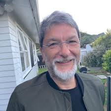 Should DJ controllers be placed flat or at an angle for comfortable use?