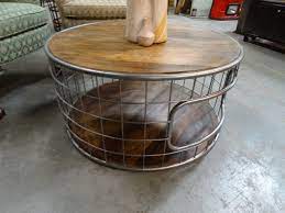 With a strong metal frame and distressed top, this round coffee table has a simple style that looks great in most settings. Round Metal Cage Coffee Table With Reclaimed Wood Top And Base Coffee Table Reclaimed Wood Coffee Table Cage Coffee Table
