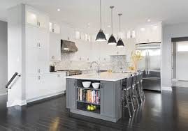 Elegance and sophistication are top of mind in this ornately beautiful space featuring white kitchen cabinets with a dark grey island. Contemporary Kitchen White With Grey Island Laurysen