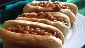 Pork and beans, bacon, hot dogs, yellow mustard, onion, brown sugar. Baked Bean Dogs