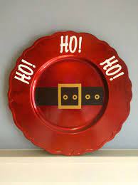 Turn dinnerware into wall decor by hanging plates with similar colors and designs in a cohesive display. Decorative Christmas Plate Christmas Plates Creative Christmas Christmas Crafts