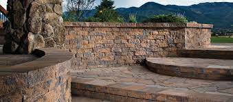 This stone paver patio features three different seating areas and a stone retaining wall to frame it in. Paver Patios Denver Co Stone Creek Hardscapes Designs
