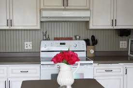 White beadboard kitchen cabinets look great and you don't even have to trash your old cabinets as these homeowners prove with their cabinet door makeover. Beadboard Backsplashes Modernize