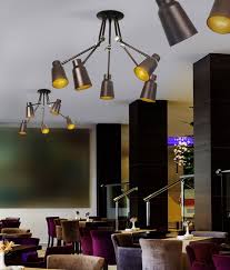 We have used soft white led lights and the whole room is well lit with the two fittings we bought. Ceiling Adjustable Jointed Arm Fitting