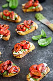 Arrange the basil and coriander on two plates. Roasted Tomato Crostini With Walnut Almond Pesto And Goat Cheese Good Life Eats