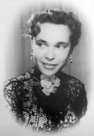 My grandma in a black lace jacket and a plaid dress made of silk in the  years 1948