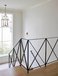 2 treads 9¾ to 14¼ deep; Iron Staircase With X Trim Transitional Entrance Foyer
