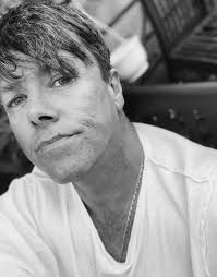 The Beatles peeping out of Brian Epstein's door, London, 1964. Photography  by Jean-Marie Périer.