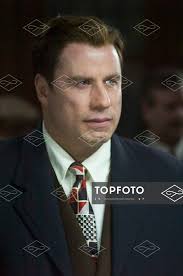 John Travolta plays Elmer Robinson, the dedicated and brooding detective;  in the film Lonely Hearts