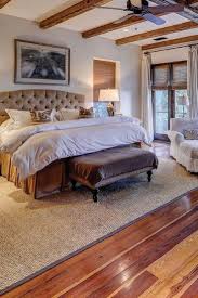 Awesome Master Bedroom With Chair Hardwood Floor And Large Area Rug Tuscanstyle Hardwood Bedroom Floors Master Bedrooms Decor Hardwood Bedroom