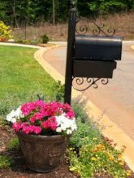 Decorate Around Mailbox Using Vines Flowers And Shrubs Mailbox Landscaping Mailbox Decor Easy Landscaping