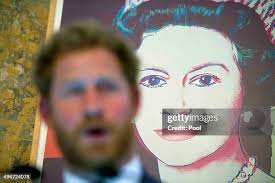 Prince Harry talks with Alejandro Becker of the Tim McGraw... News Photo