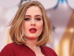 Adele with cool-red lipstick and sleek eyeliner