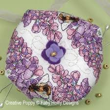 This counted cross stitch pattern of lilacs was created from a painting by max streckenbach. Faby Reilly Designs Lilac Biscornu Cross Stitch Pattern