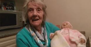Nan with dementia cradles Baby Annabelle doll she got for Christmas.
