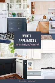 The grey tile below picks up the blue in the cabinets. White Appliances As A Design Feature In The Kitchen Little House Of Could