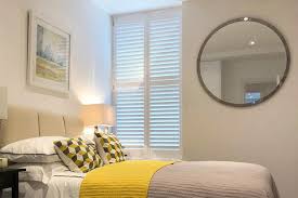 Luxury white indoor plantation shutters, closed shutters. Bedroom Shutters By Plantation Shutters