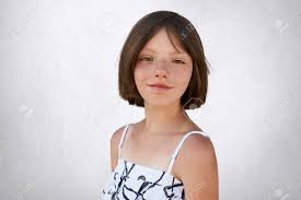 As a result, they term persons of irish descent having dark brown or black hair as black irish often suggesting the darker hair, eyes or complexion derives from survivors of the spanish armada in ireland. Portrait Of Freckled Little Girl With Dark Short Hair Hazel Eyes And Thin Lips Wearing Black And White Dress Posing At Camera Against White Background Adorable Girl With Freckles Childhood Concept Stock