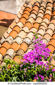 We also carry various types of roofing shingles, including architectural roof shingles, which are thicker and heavier than your standard shingles to provide better durability against the elements, and hip and ridge roof shingles for coverage at the peak of two slopes of a roof. Purple Flowers On Mediterranean Roof Tiles In Sunny Day Canstock