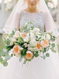 A large king protea and some greenery around it with a cascade for a stylish modern look. Wedding Event Floral Design On The Emerald Coast Beyond Boukates