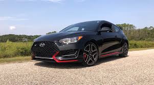 A massive grille is framed by a pair of full led headlights with projectors, while a massaged hood, gloss black mirror caps, and a sloping roofline make it look more like a small coupe than a hot hatch. 2019 Hyundai Veloster N Performance Pack Ultra Black 29