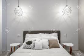 They can also be used to light a vanity in a master suite. Modern Bedroom With Double Bed Two Bedside Tables And Two Pendant Stock Photo Picture And Royalty Free Image Image 152803485