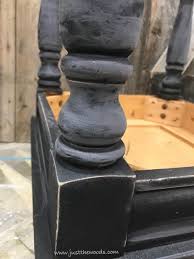 Four bottom cabinets open to one large storage area with shelf inside. How To Get Farmhouse Style Black Distressed Furniture