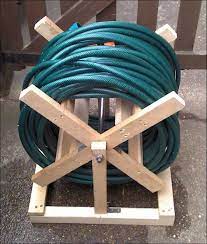 Ideas Diy Wooden Hose Storage For Garden Appliances Plus Long Blue Hose 014 Garden Hose Storages Useful At On Garden Hose Storage Garden Hose Reel Hose Reel
