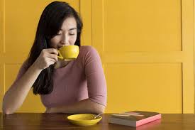 Young couple on first date drinking coffee. Asian Woman Drinking Coffee By Eyes On Asia