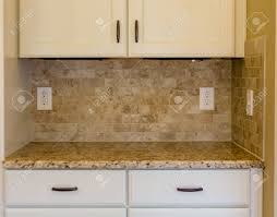 granite countertops and tile backsplash