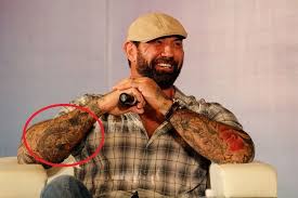 Bautista stands and has him take a photo with his phone. Dave Bautista S 33 Tattoos Their Meanings Body Art Guru