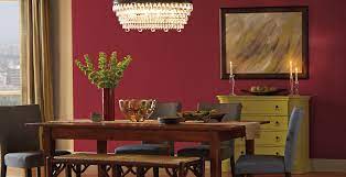 Dramatic red dining room with ebony finished floor, red walls and ceiling, dining room side chairs and 2 wing chairs are upholstered in dark chocolate brown mohair, large area rug is custom in red with dark brown greek key border. Red Dining Room Ideas And Inspirational Paint Colors Behr