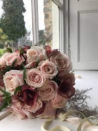 Blush pink rose gold wedding flowers. Blush Pink Rose Bouquet With Burgundy Ranunculus And Silver Fern Rose Gold Bouquet Pink And Burgundy Wedding Burgundy Wedding Colors