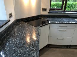 This durable granite is an excellent choice for both commercial and residential projects including countertops, backsplashes, floors, and is an exceptional option for cladding of exterior walls. Blue Pearl Granite Worktops In North Wales On A White Gloss Kitchen Kitchen Remodel Countertops Kitchen Tiles Design White Gloss Kitchen