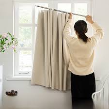 Specialist hanging heavy velvet curtain on newly installed wooden pole