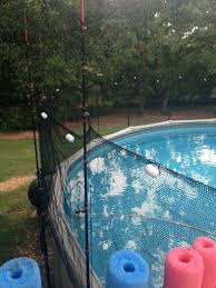 Fish Net Around Pool Held Up By Fishing Poles To Keep Balls In Pool Outdoor Pool Pool Accessories