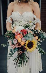 Portrait of bride and groom on sunflower field. Mustard And Navy Blue Color Combos Primrose Sunglow Yellow Pantone 2018 Blue Color Co Sunflower Wedding Bouquet Wedding Flower Trends Wedding Bouqet