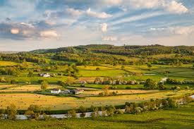 Car driving on countryside road in wales,uk.idyllic landscape,lambs,green hills with trees,blue sky. 10 Best Places For Landscape Photography In South Wales Nature Ttl