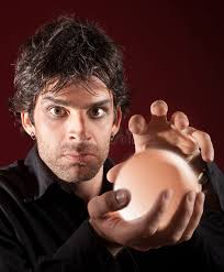 Male Fortune Teller Reading a Future by Tarot Cards in the Light of Candle  Concept. Stock Photo