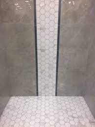 The small size of the individual tiles means they conform to the slope and shape of the shower floor better than a larger tile would. Create A Waterfall Accent In Your Shower That Flows Right Into The Shower Pan We Love How Our Polished T Shower Tile Designs Shower Stall Bathroom Shower Tile