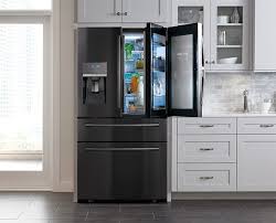 Watch Now This Kitchen Blends Traditional Modern And Eclectic Styles Black Stainless Steel Kitchen Samsung Kitchen Black Stainless Appliances