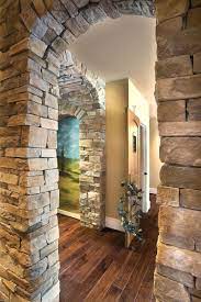 A faux stone arch surrounds a country scene. Country Ledgestone Mutual Materials Stone Archway Country Ledgestone Stone Walls Interior