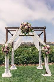 Rustic Wedding Ceremony Arch Idea Outdoor Wooden Arch With White Fabric And Floral Arrange Wedding Ceremony Arch Wedding Ceremony Flowers Wedding Arch Rustic