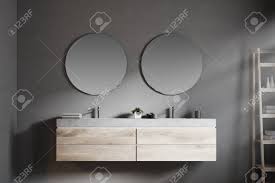22x34 bevel edge framed mirror, dark brown by infurniture inc., (16) $130$200. Modern Bathroom Double Sink With A Round Mirror Hanging Above Stock Photo Picture And Royalty Free Image Image 103740012