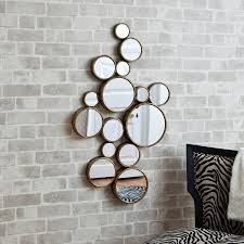Consider a modern mantel mirror to draw the eye upward, highlighting other decor on the shelf and make the room appear bigger all at once. Fifteen Circles Mirror