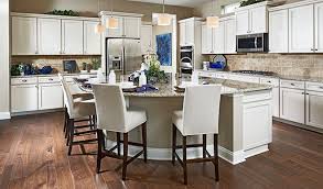 White Cabinets Neutral Granite And A Rounded Island Are Just A Few Of The Many Eye Catching Features Of This Inviting Kitchen Log Home Kitchens Home New Homes