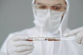 Person Holding Test Tube and Syringe · Free Stock Photo