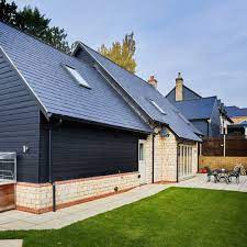 External Brick And Timber Cladding House Budget Self Build Cottage Dark Grey Slate Roof Tiles With White Cot Exterior Cladding Cladding Country House Design
