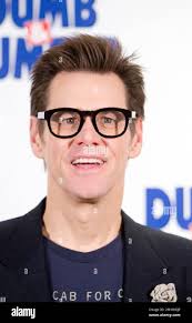 File- This Nov. 20, 2014, file photo shows Jim Carrey posing for  photographers for the "Dumb and Dumber To" photo call in Paris, France.  Carrey says a wrongful death lawsuit filed by